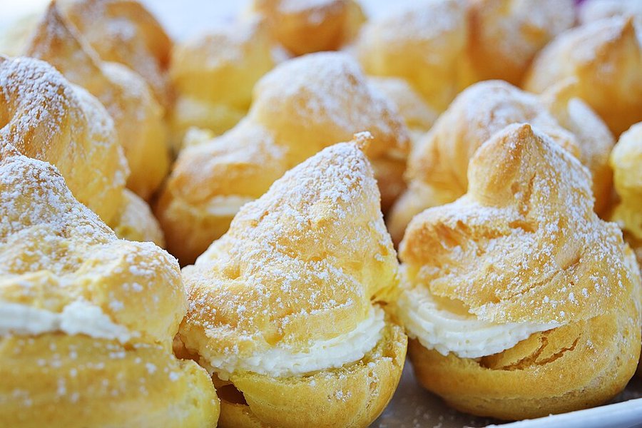 Fresh cream puffs on a board